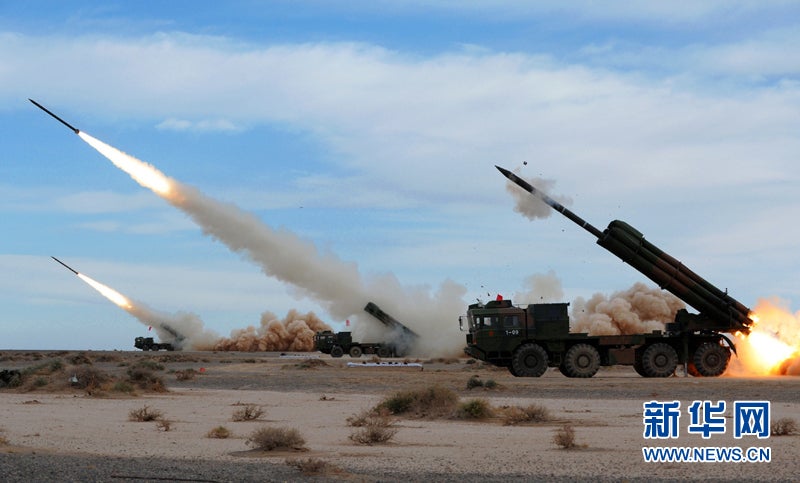 The Lanzhou Military Region's PHL rocket launchers fire a barrage during exercises. While these 300mm rockets are similar in size to the Russian SMERCH, they use a different rocket motor and warheads.
