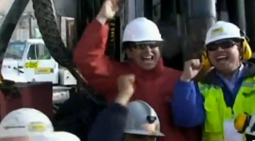 Chilean rescue workers celebrate as the drill boring the rescue shaft finally broke through to reach the 33 men trapped 2,000 feet below the surface.
