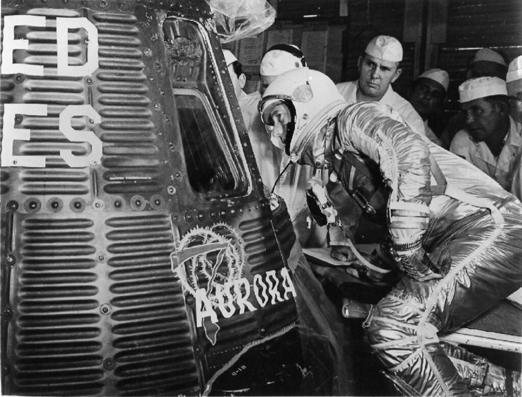astronaut Carpenter looking into the Aurora 7