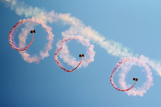As part of a celebration for China's upcoming Army Day, parachuters from the Aerobatic Team descended from the sky.