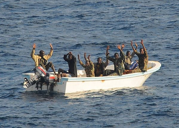090211-N-1082Z-111 GULF OF ADEN (Feb. 11, 2009) Suspected pirates keep their hands in the air as directed by the guided-missile cruiser USS Vella Gulf (CG 72) as the visit, board, search and seizure (VBSS) team prepares to apprehend them. Vella Gulf is the flagship for Combined Task Force 151, a multi-national task force conducting counterpiracy operations to detect and deter piracy in and around the Gulf of Aden, Arabian Gulf, Indian Ocean and Red Sea. It was established to create a maritime lawful order and develop security in the maritime environment. (U.S. Navy photo by Mass Communications Specialist 2nd Class Jason R. Zalasky/Released)