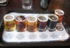 The sampler flight from Pelican Pub and Brewery in Pacific City, Oregon, shows the range of colors and opacities beer can have. From left to right, the beer styles are: cream ale, scottish style ale, india pale ale, brown ale, stout, and a seasonal whose identity I cannot remember.