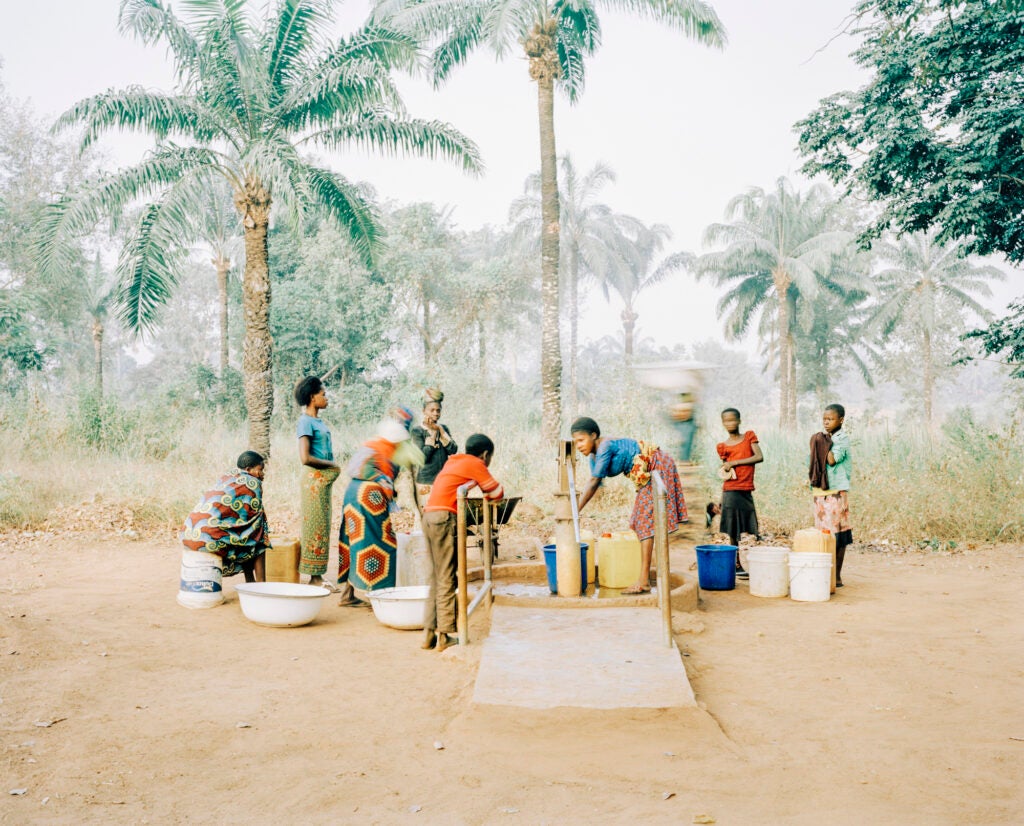 Women and children gathering at a Water Pump in Nigeria