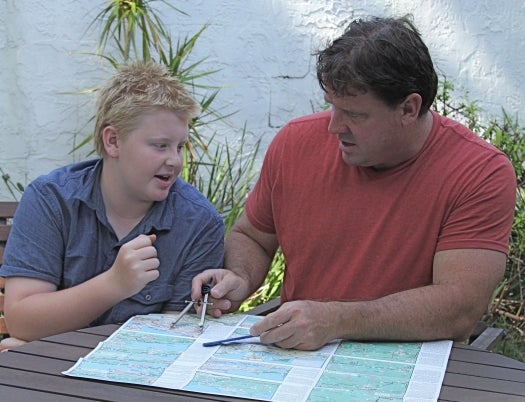 A month before the tour, the father son team are pictured planning out their route.