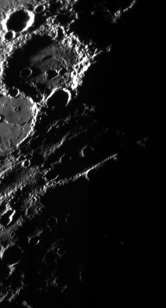 The Sun casts deep shadows in this image, emphasizing the texture and topography of the terrain along the terminator (day/night boundary). The large crater at upper left has a rough rim and walls, and the floor of this crater has a sunken inner circular area containing an irregular depression (or pit) that is entirely in shadow. Just to the south-southwest is the right half of another large crater of about the same diameter, but which has been filled nearly to its rim with smooth material likely of volcanic origin. These two close neighbors, one empty and one full, attest to Mercury's surprisingly complicated geological history.