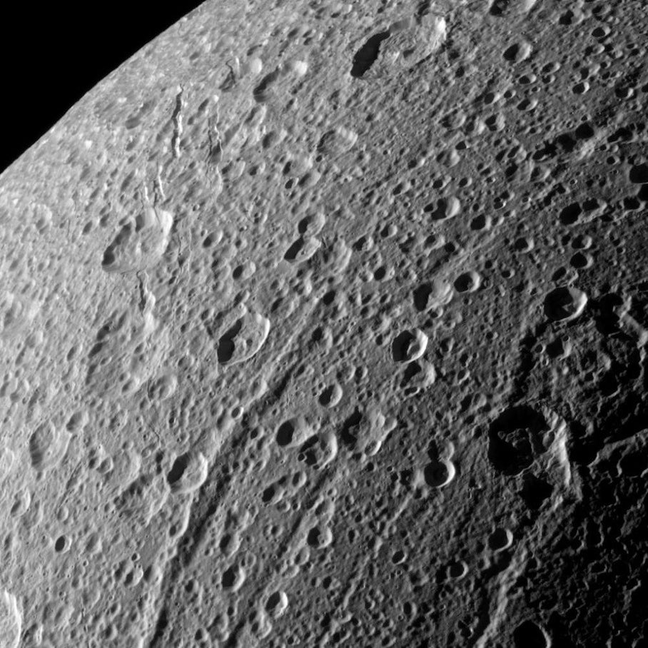 Janiculum Dorsa, a mountain that appears as the long, raised scar in the middle of this Cassini image, is providing new evidence that the Saturnian moon Dione was recently active.