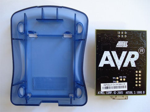 A clear blue plastic case with a black AVR microcontroller next to it.