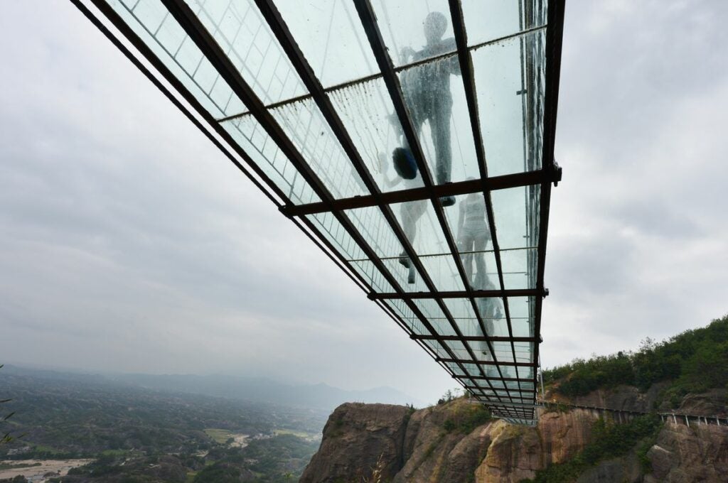 The world's <a href="http://www.theverge.com/2015/9/29/9413571/china-biggest-glass-suspension-bridge">longest glass suspension bridge</a> opened in the Shiniuzhai National Park in China.  The bridge spans 984 feet, but all that stands between travelers and the 590 foot drop is an inch of glass.  And a solid steel supporting structure, just in case.