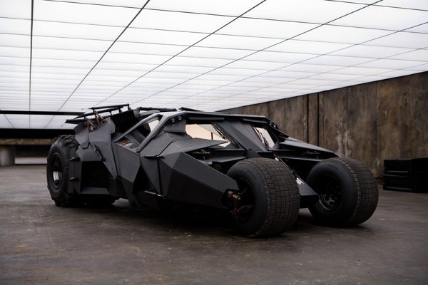 The Batmobile (or the Tumbler as it is called in this newest incarnation) is actually a real car, or more accurately several different cars that were built specifically as prototypes for the movie. No CGI here, not even the flames ejected from the rocket engine. All of the scenes with the Batmobile that we see in <em>The Dark Knight</em> were filmed using these prototypes. When the Batmobile is racing along city streets, that's one of the "race versions" which were constructed around a stripped out NASCAR race car at a cost of about $250,000 each. These are high performance vehicles capable of accelerating to 60 mph in 5 seconds. They are each equipped with special suspension systems similar to those found in Baja racing trucks, and in order to help the car negotiate high speed turns, each rear wheel is equipped with extra brakes that can be activated separately with hand levers. Engaging the supplemental brakes on only one side provides a greater net torque on the car and a tighter turning radius compared to normal braking. The prototype is also outfitted with a rugged steel frame, which, with the aid of the suspension, allows the car to execute 30-foot jumps without crumpling on impact. And it attains a top speed over 100 mph. There is also a much less outfitted "opening version" that they use to film Batman getting in and out of the vehicle. The "jet version" is one of the race versions outfitted with propane tanks that ignite for scenes involving rocket thrust, and there is even a miniature version which they film jumping ravines and other obstacles. However, the scene in <em>Batman Begins</em> where he jumps through the waterfall was actually filmed using the "race version." It really can jump!