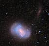 This is what's called a "stealth merger" of two dwarf galaxies. It's not a painless merger, though; apparently the smaller galaxy gets "<a href="http://www.universetoday.com/93554/stealth-merger-of-dwarf-galaxies-seen-in-new-images/">torn apart</a>" upon impact, contributing to the size of the larger one. [via <a href="http://io9.com/5885206/picture-of-the-day-feb-14-2012">io9</a>]