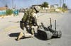 soldier using the the Talon small mobile military robot
