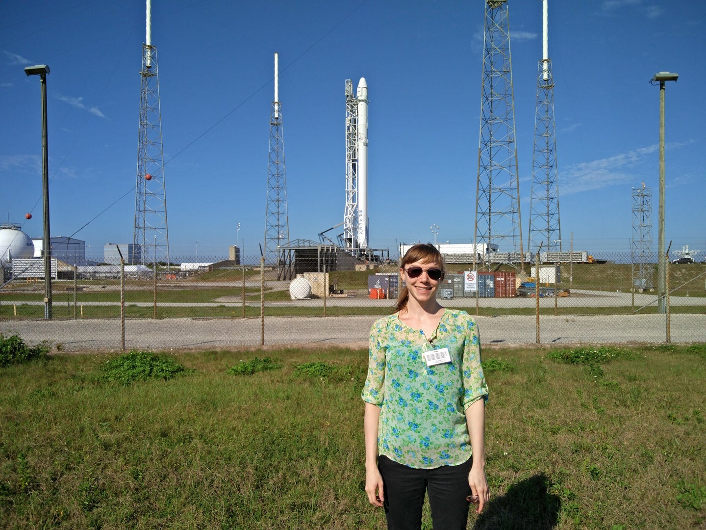 popular science editor poses for a picture in front of the falcon 9
