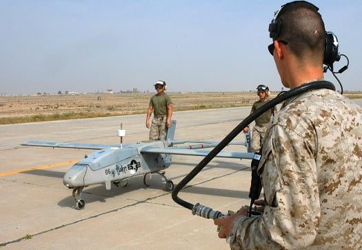 AL TAQADDUM, Iraq (March 30, 2005) - Staff Sgt. Richard E. Seeley, UAV external pilot and native of Eustis, Fla., watches as Marines from Marine Unmanned Aerial Vehicle Squadron 2 taxi a Pioneer UAV down the flight line prior to take off. External pilots control the aircraft during takeoffs and landings, while internal pilots in the ground control station control them during the mission.