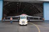 people pulling the X-47B out of the aircraft hangar