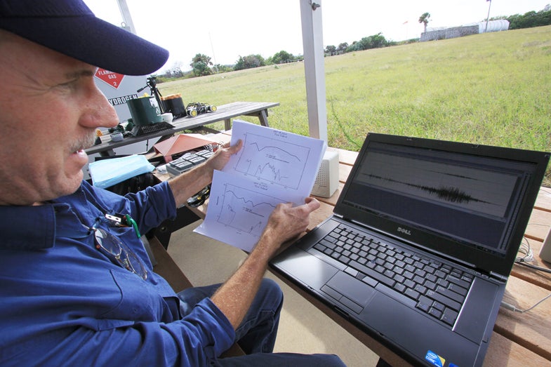 John Lane looks over data recorded from his laser system as he refines his process and formula to calibrate measurements of raindrops.