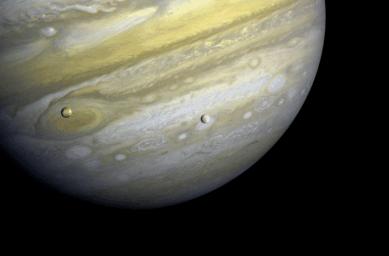Voyager 1 took this photo of Jupiter and its moons Io (shown here) and Europa in 1979. Io is about 220,000 miles above Jupiter's Great Red Spot.