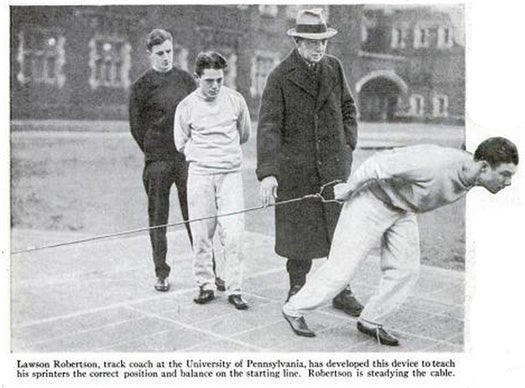 Lawson Robertson, coach of the 1928 U.S. Olympic track team, grooms new sprinting stars using his invention: a steel cable fastened to the ground on one end, with a handgrip on the other. The device is supposed to help the runner find the sweet spot for his starting position--the one that will "give him the greatest forward impetus, without stumbling at the get-away." Read the full story in Track Device Teaches Sprinters Fast Start.