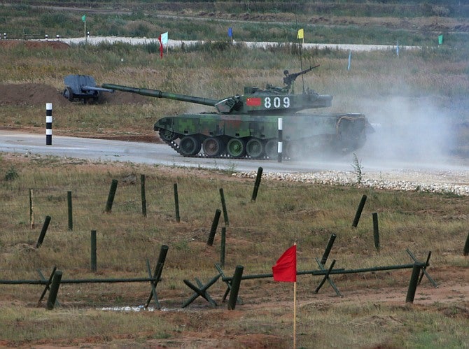 A ZTZ-96A tank speeds away into the 20km obstacle course of the Tank Biathlon in Russia.