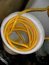 The vapor from the pyrolysis reaction is collected in 50 feet of yellow tubing, which feeds out of the char separation system. The vapor condenses to bio-oil at room temperature. Cooling the vapor faster -- using ice, for example -- makes the oil too thick, and it gets clogged in the tubing.