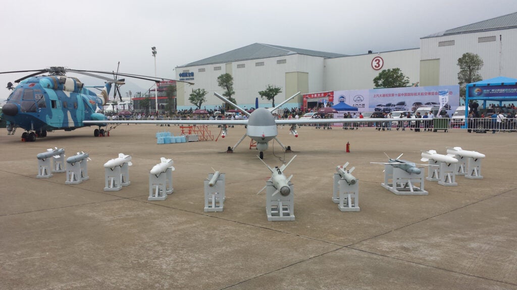 At Zhuhai 2014, the WJ-1 UCAV, formerly known as the Pterodactyl, basks in the glow of interested customers and a wide variety of glide bombs, guided rockets and anti-tank missiles displayed before it.