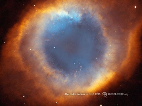 This detailed picture of the Helix Nebula shows a fine web of filaments, like the spokes of a bicycle, embedded in the colorful red-and-blue gas ring around this dying star. The Helix Nebula is one of the nearest planetary nebulae to Earth, only 650 light-years away.