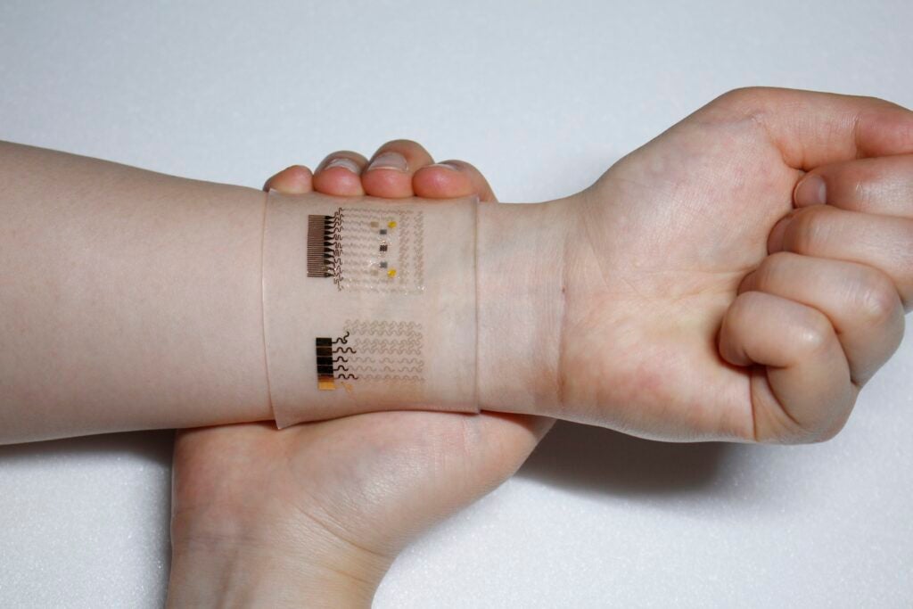 dual function diabetes patch on a person's hand
