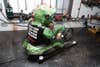 A green hog demon on a power tool motorcycle.