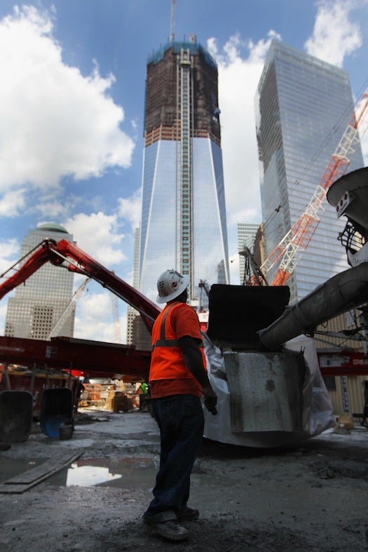 The building rising behind this New York construction worker is One World Trade Center, which is destined to achieve a gold level certification from LEED (Leadership in Energy and Environmental Design).