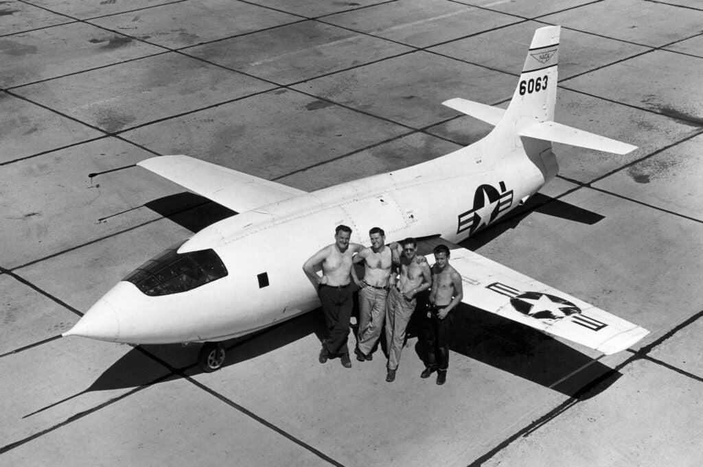 Ground crews taking advantage of the desert site's remote location to ditch their uniforms. With the X-1 in 1949 are Eddie Edwards, Bud Rogers, Dick Payne, and Henry Gaskins.