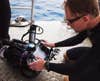 Scott prepares the handheld Shark Marine Navigator system, which contains sonar, lights, and cameras.