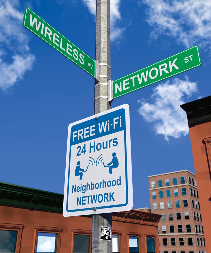 A street sign showing the intersection of Wireless Avenue and Network Street, with another sign advertising free WiFi for 24 hours on a neighborhood network.