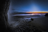 Here's Hug Point on Oregon's Pacific coast. On the left is a small waterfall. Above the sunset is a wash of white light called zodiacal light, AKA "false dusk" or "false dawn." Zodiacal light results from sunlight reflecting off of dust grains in the inner solar system. It appears only at sunrise and sunset, usually in the spring or autumn.
