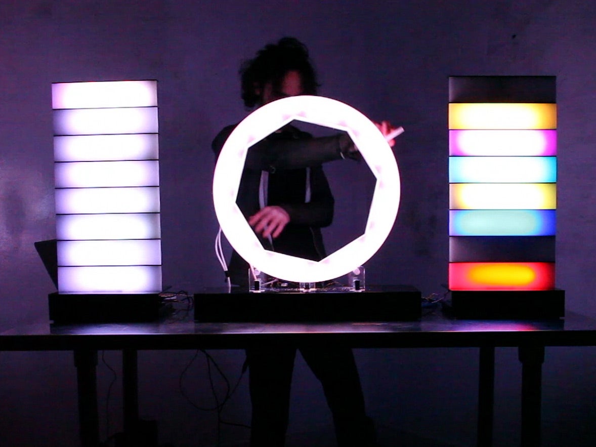 Played by touching an octagonal surface connected to two light towers, the nomis creates sounds that can be used in repetition. When a part of the octagon is touched, it lights up and produces a note. Players can tap out a tune and then loop it by spinning the octagon around. See the full light and sound performance <a href="http://vimeo.com/98813434">here</a>.