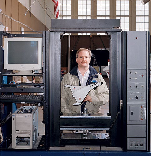 <em>Jeff Greason's rocket company, XCOR, would have delighted Princeton physicist Gerard O'Neill, for whom the human colonization of space was an imperative. Standing behind a tension-compression machine (used to test the strength of materials), Greason holds a model of XCOR's space plane, the Xerus, which is designed to take tourists on space rides.</em>