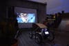 PopSci's DIY projector projecting a movie onto a sheet on the side of a house.