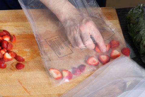 If you have a vacuum sealer, place the strawberries into a bag, and seal it at maximum vacuum plus 30 seconds.