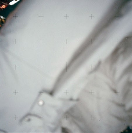 This photo, an accidental shot, shows the Reseau plate grid over a blurry bit of spacesuit.