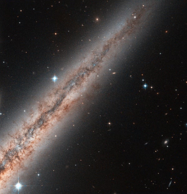 Hubble Peers Into the Constellation Andromeda to Capture a Spiral Galaxy in Profile