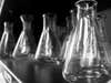 A collection of clean, empty beakers, in black and white.
