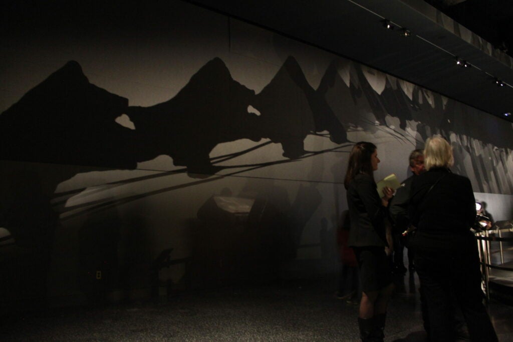 The titanosaur casts a long shadow in its dimly lit hall.
