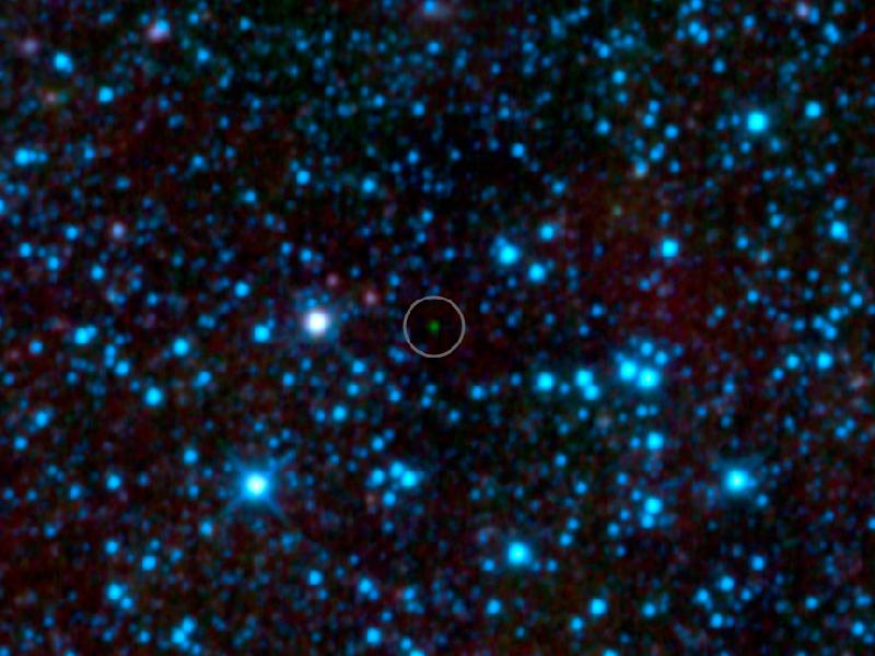The green dot in the center is the coldest brown dwarf star ever discovered, with a temperature less than that of a human body (less than 80 degrees F).