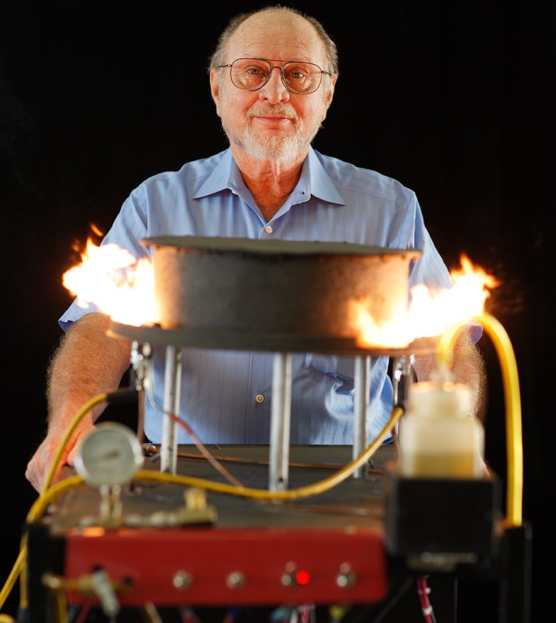 Harry Schoell shows the uncovered combustion chamber in his steam engine.