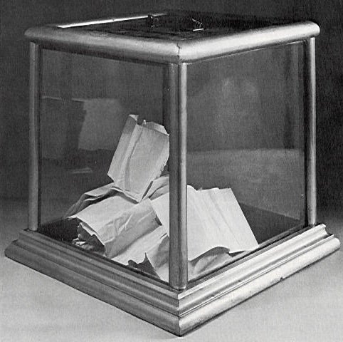 For most of the nineteenth century voters scrawled their vote on a piece of paper and stuck it in a ballot box [such as the one from c. 1900 at left]. Parties soon began passing out preprinted ballots with their slate of candidates on it.