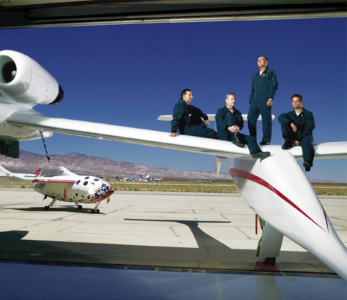 From left, Brian Binnie, Doug Shane, Mike Melvill and Peter Siebold on <em>White Knight</em>. In the background, <em>SpaceShipOne</em> awaits its final two flights.