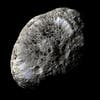 One of more than 60 of Saturn’s moons, Hyperion consists largely of ice. Its surface is covered in irregular, sharp-edged craters dusted with a mysterious dark material, which is thought to have originated on Phoebe, another of Saturn’s moons.