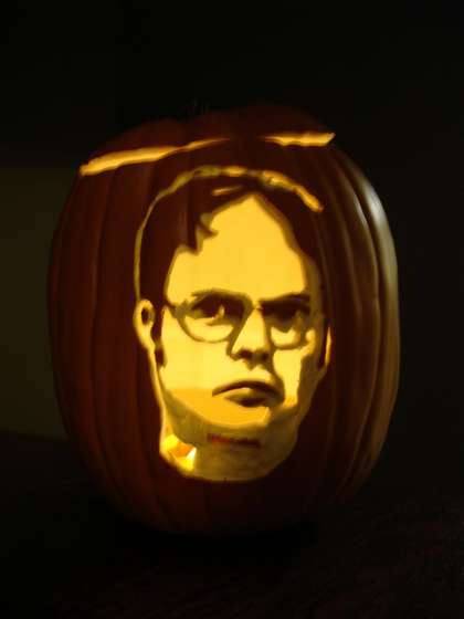 A Dwight Schrute Jack-o-lantern made with a backlit photo of Dwight Schrute from The Office.