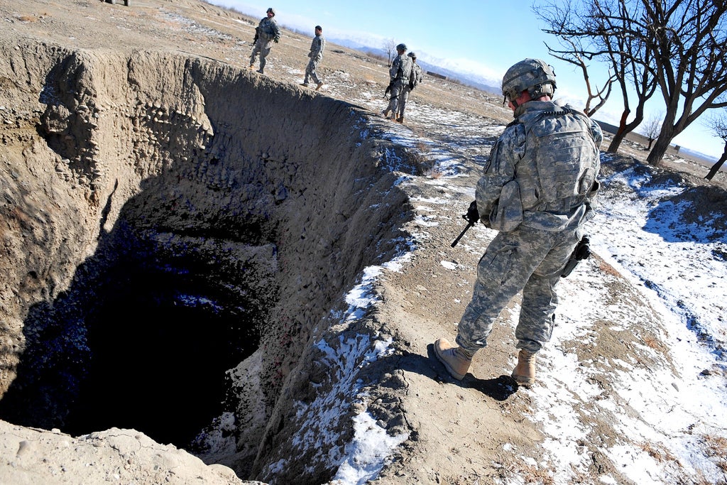 U.S. Army Soldiers from 1st Battalion, 501st Infantry Regiment, 4th Brigade, 25th Infantry Division, search the location of a Improvised Explosive Devise cache found in Sharana, Paktika province, Afghanistan, Feb. 15.