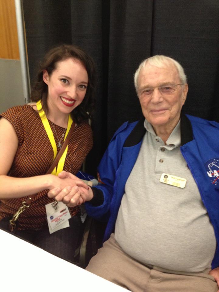 a woman shaking hands with old astronaut Carpenter