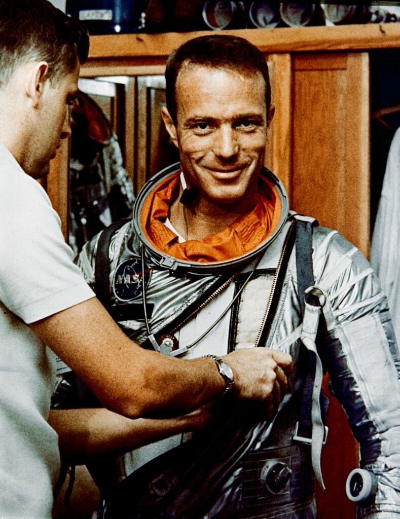 astronaut Carpenter getting his suit adjusted before his Aurora 7 flight