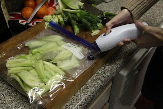 <strong>85°C, 40 minutes</strong><br />
To cook sous vide successfully, you want as little air in the bag as possible--so it doesn't insulate the food, and so your bags don't float to the surface as gasses are released during cooking. The Sous Vide Supreme doesn't come with a vacuum sealer, but they sent a Reynolds Handi-Vac hand-held pump that worked fairly well, creating a tight seal inside its own special bags. You can also use a Food Saver, or follow Momofuku chef David Chang's advice and simply force the air out of the bag by dipping it almost entirely into the water, sealing it when the enough air has been removed to keep it from floating. Always use high quality bags to prevent ruptures, and to minimize the risk of nasty plastic chemicals leaching into your food. Most vegetables cook through at 85 degrees in just under an hour. Some will probably vary, but I followed Thomas Keller's recipe (omitting a few purees) to make delicious caramelized fennel seasoned with fines herbs and some white wine in the bag.